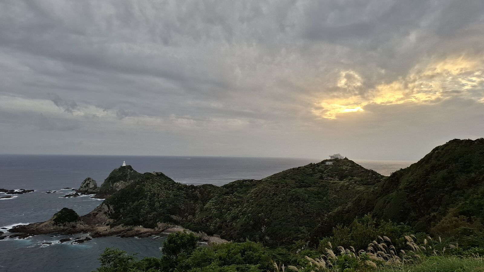 Golden hour at Cape Sata lighthouse, Japan's southernmost mainland point, warm light over dramatic Pacific cliffs