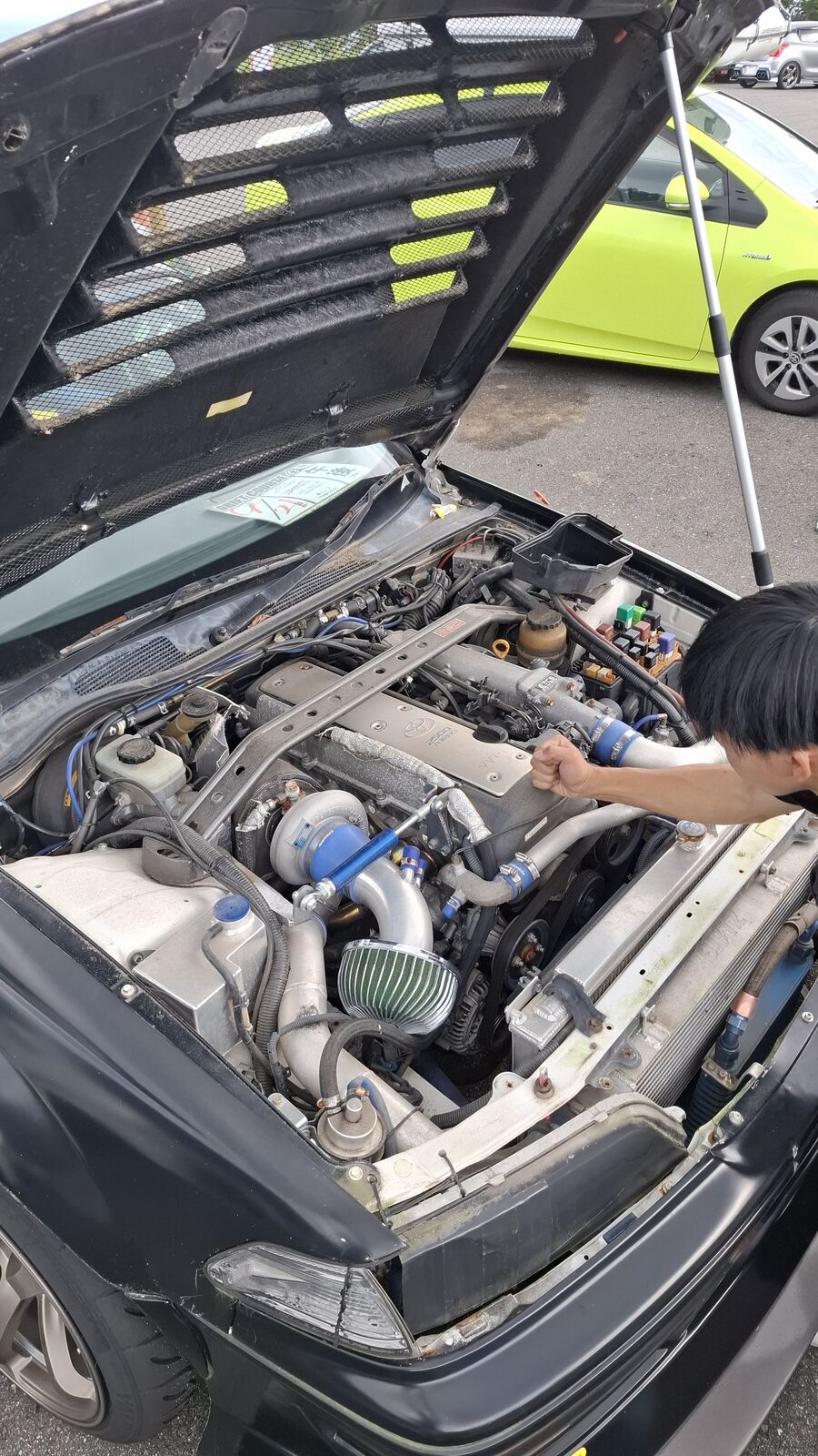 Close-up overhead view of a turbocharged engine bay with intercooler piping