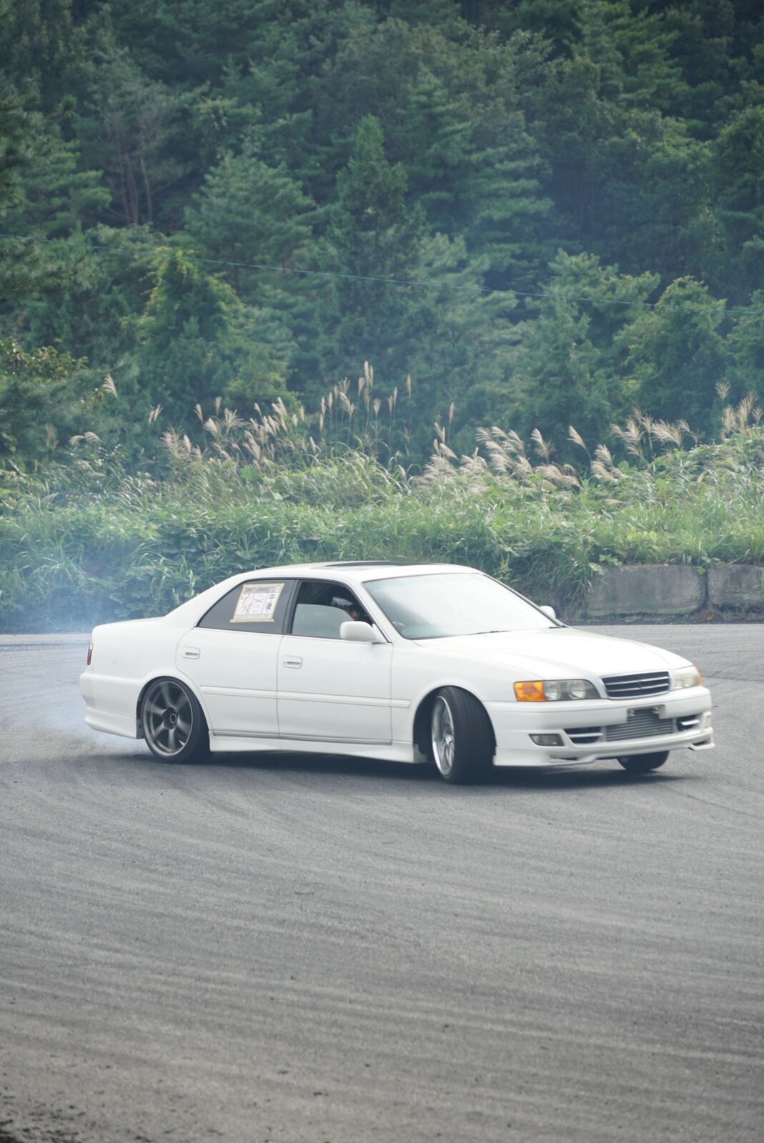 Drift action on the practice course with forest backdrop