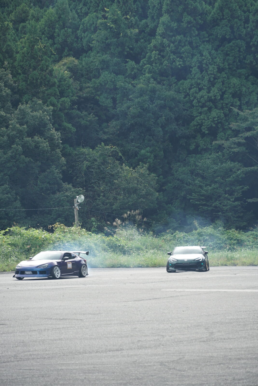Two drift cars chasing each other on the practice course