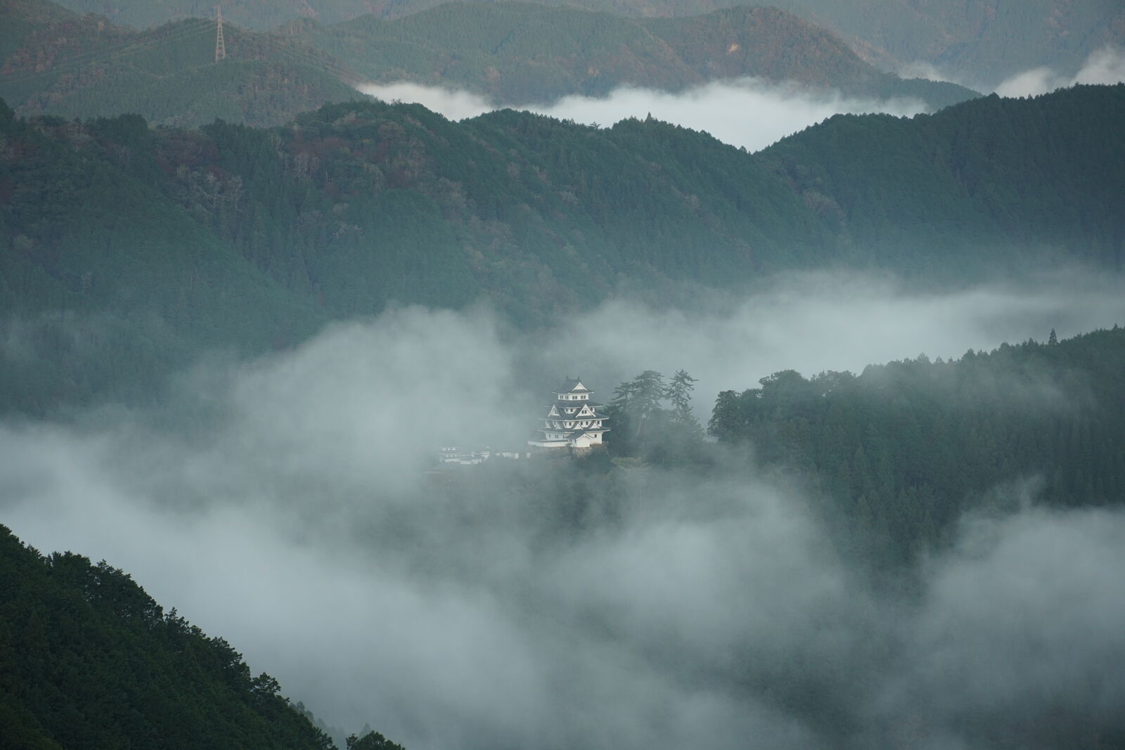 Gap in the clouds revealing the town below while the castle stands above