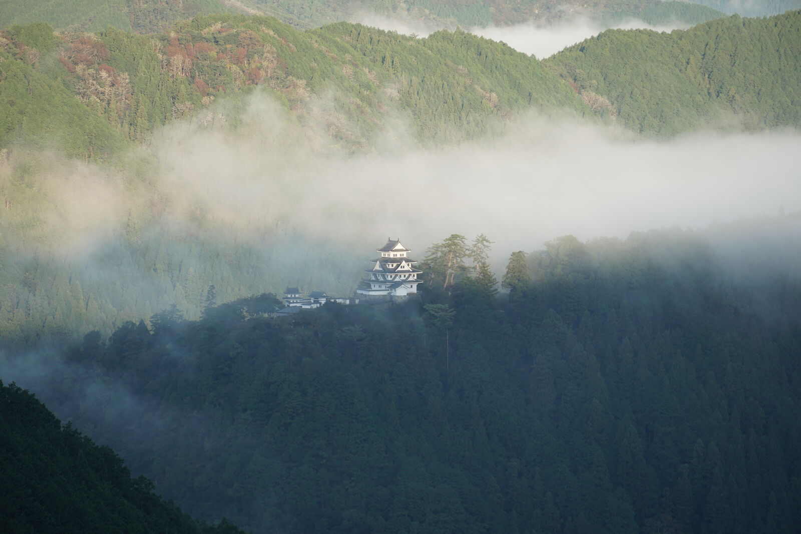 Gujo Hachiman Castle in morning light with the last wisps of cloud disappearing from the valley