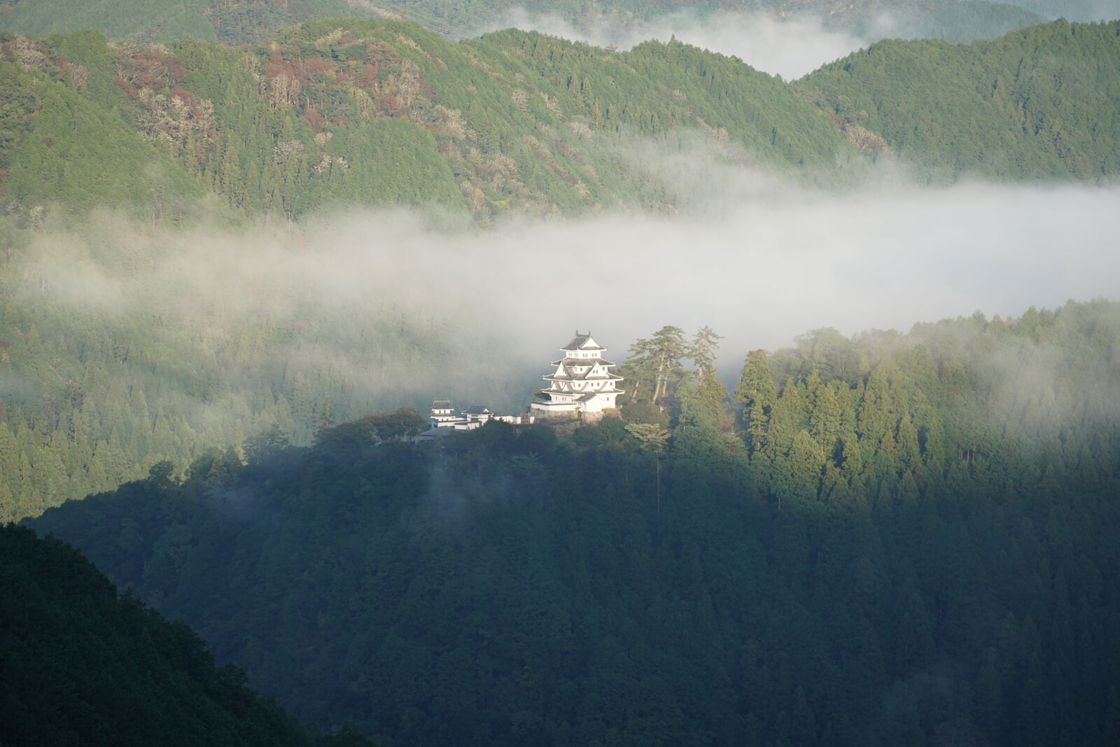 Castle bathed in warm morning sunlight as the last clouds dissolve
