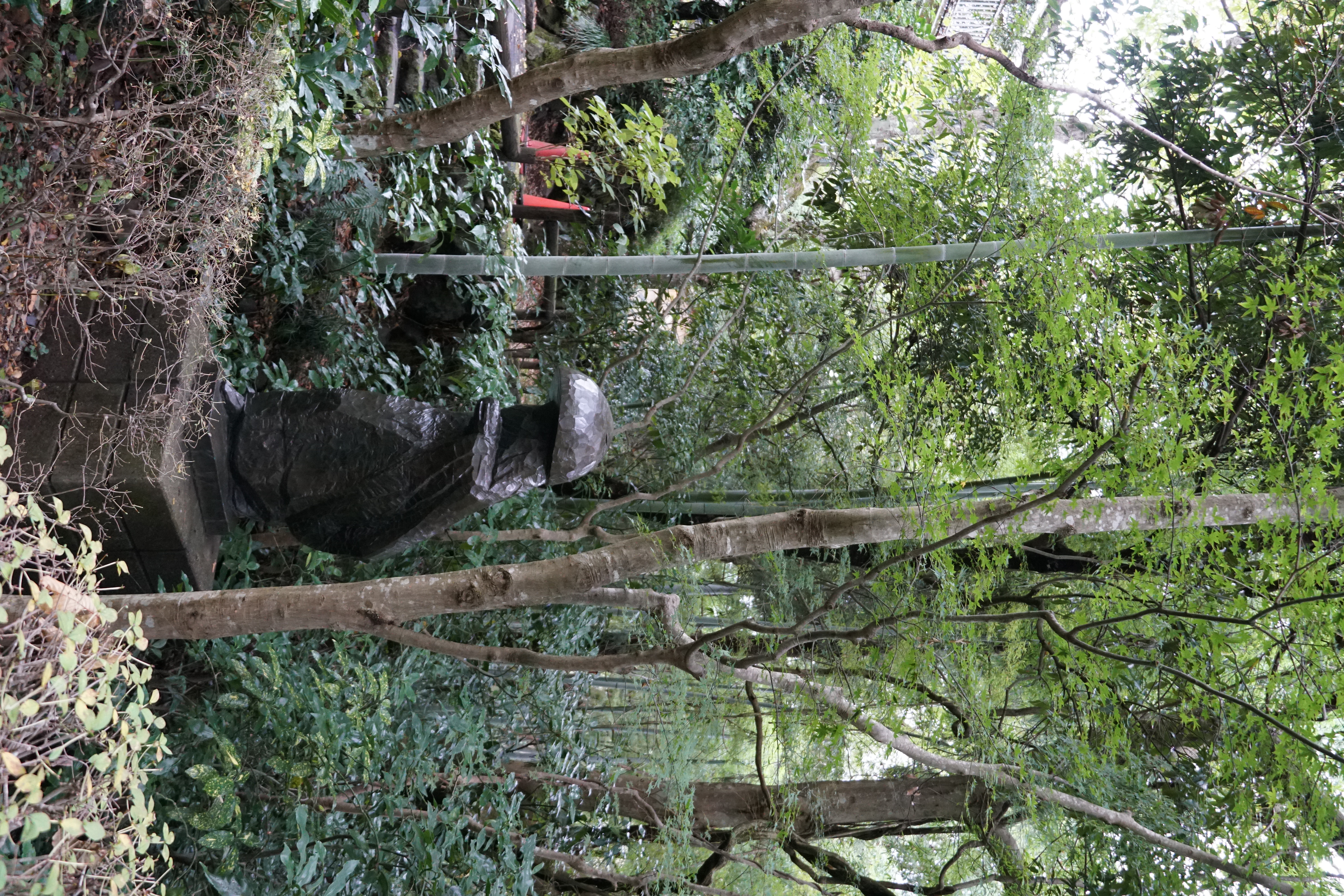 Bronze figure group on the lawn with trees behind