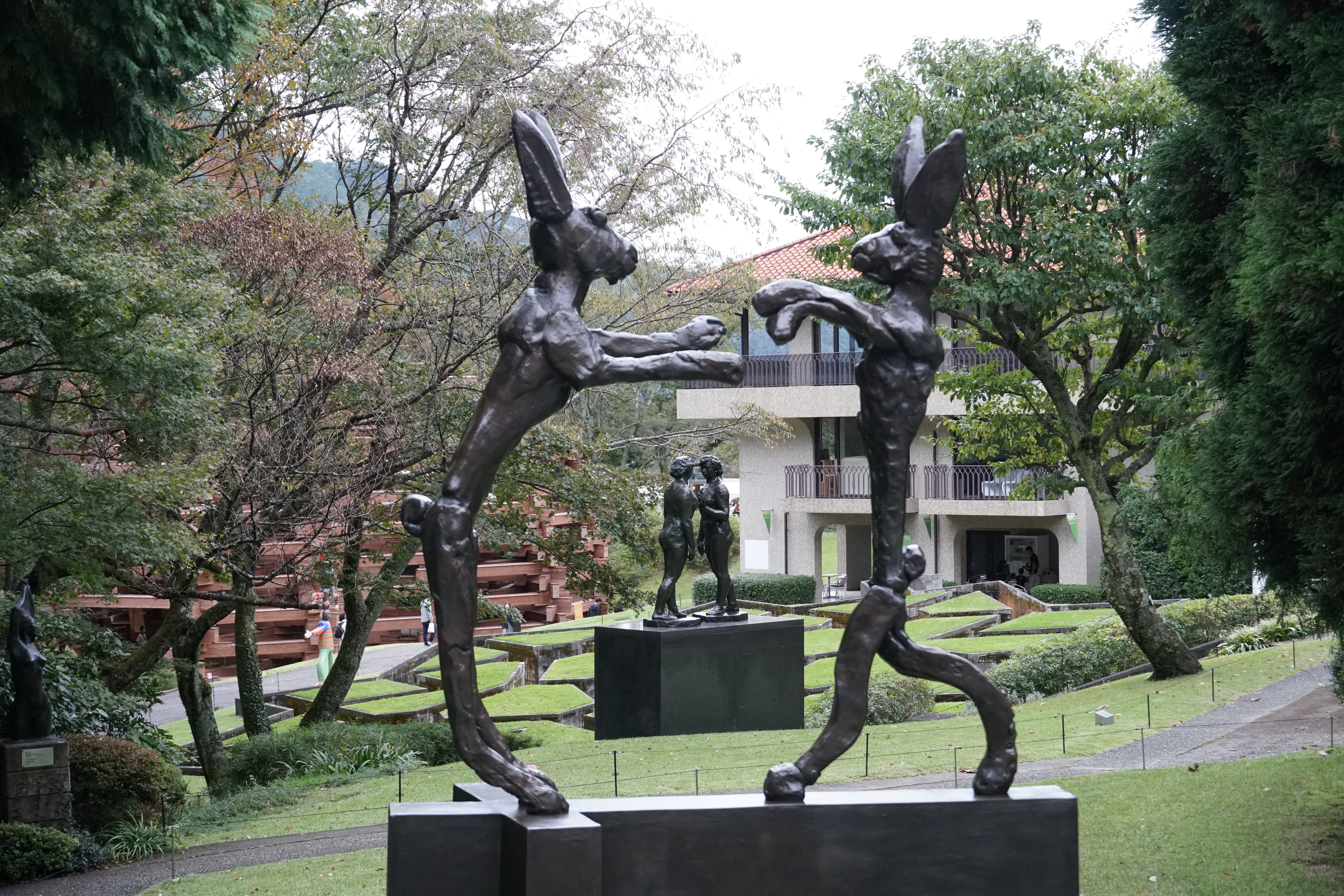 Bronze figures interacting in sculptural group