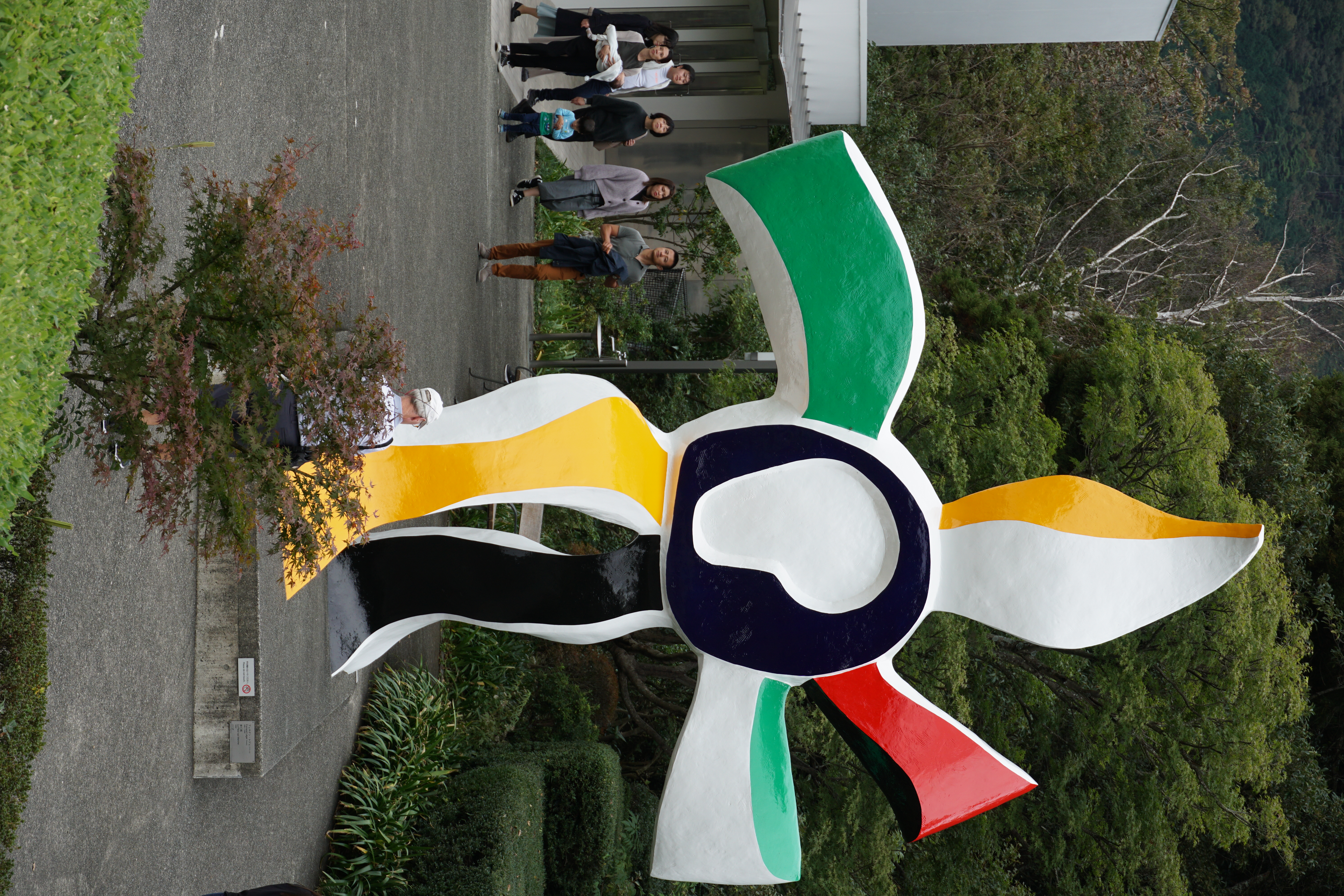 Large colorful pinwheel-shaped sculpture on the lawn