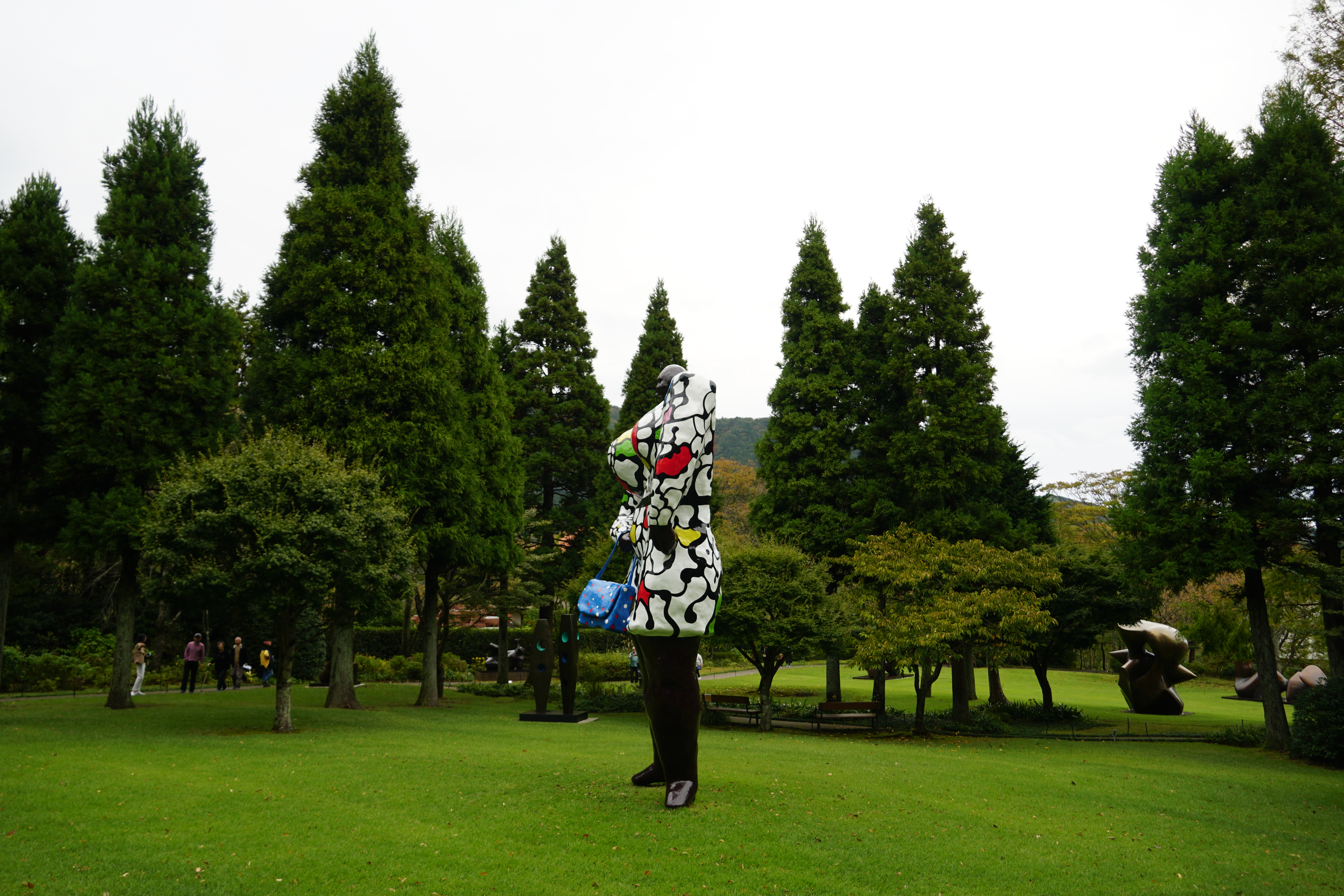 Colorful pop art figure on green lawn at Hakone Open-Air Museum