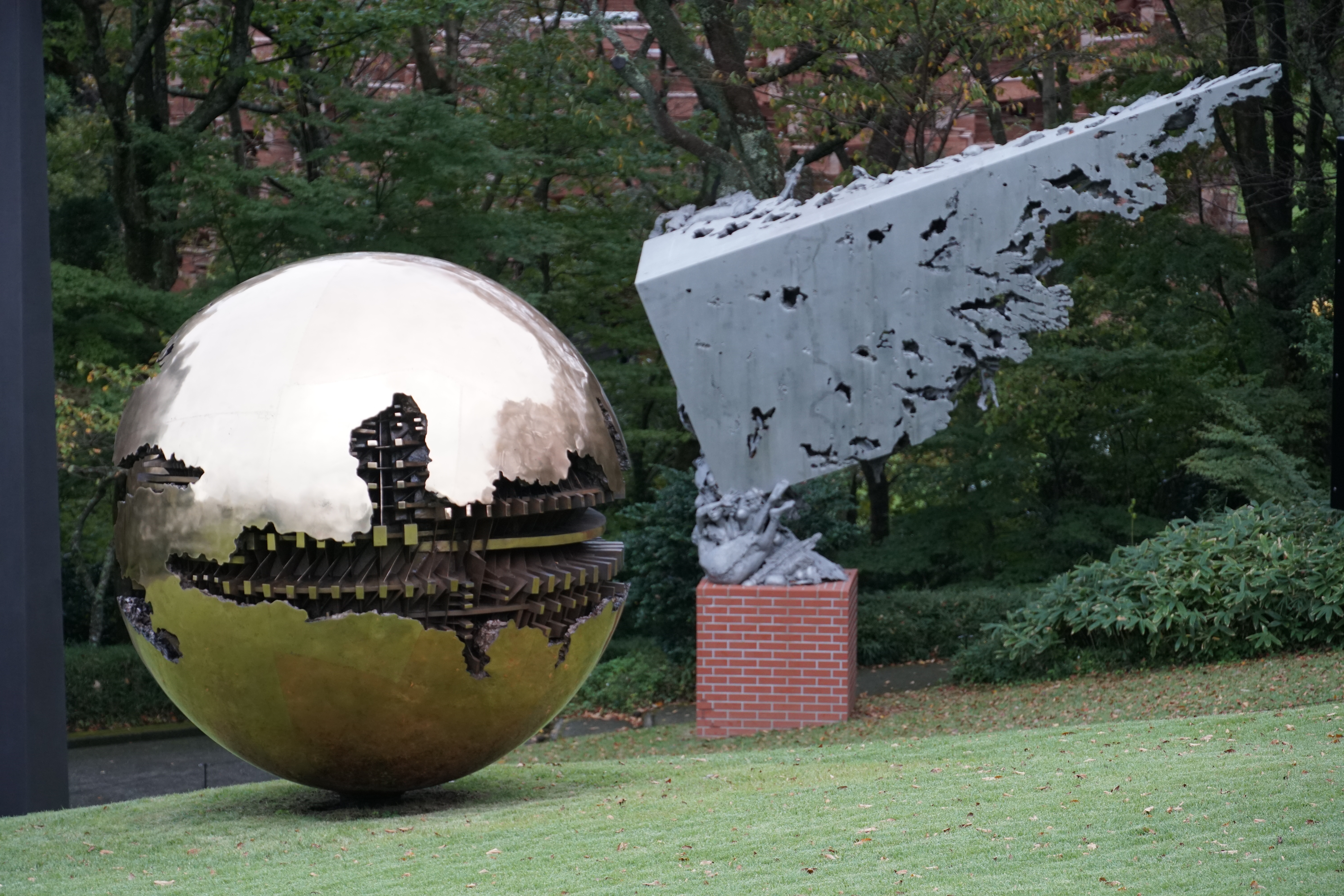 Golden reflective sphere sculpture mirroring the landscape