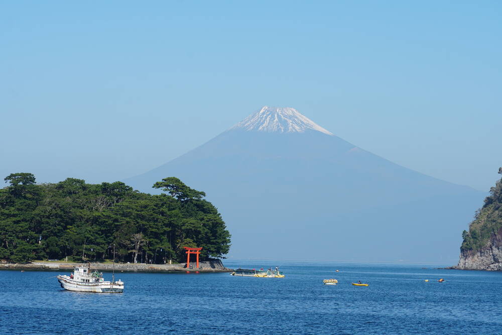Fishing boats docked at Heda harbour, their colorful hulls reflected in the calm morning water