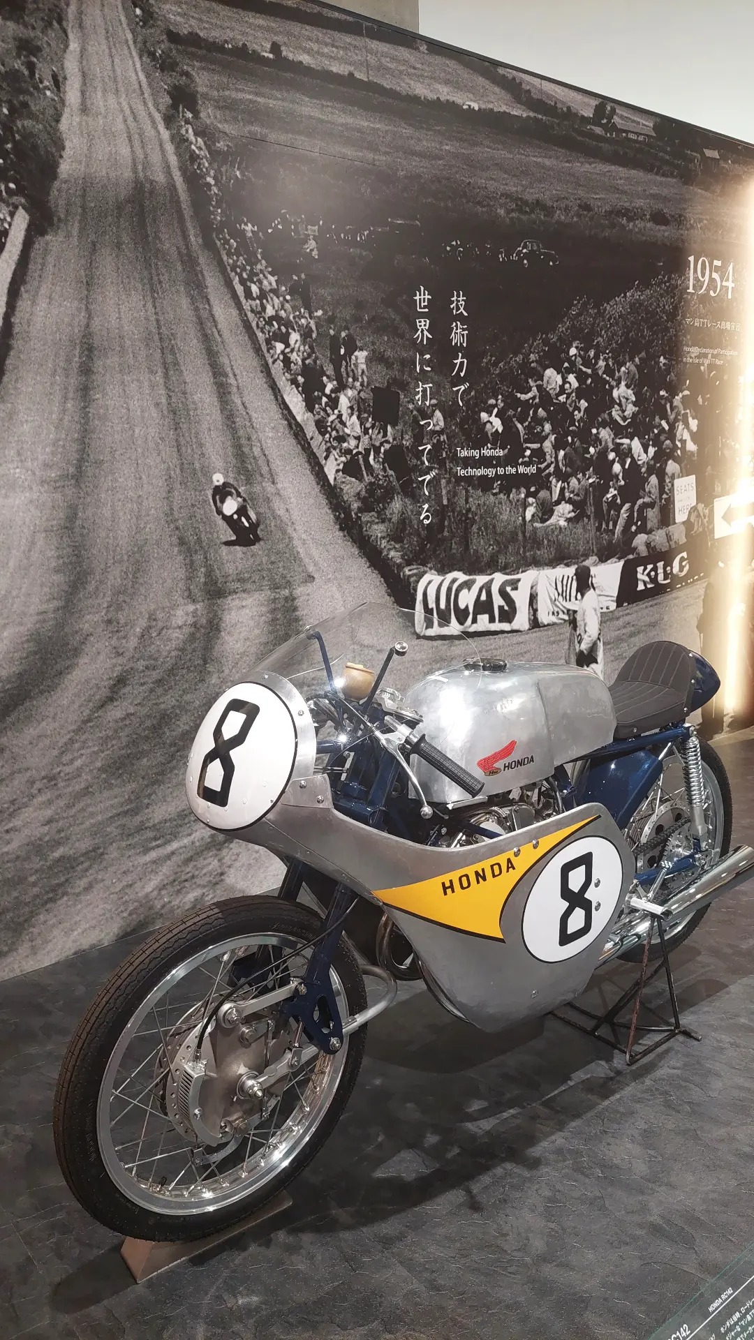 Honda racing motorcycle number 8, silver and yellow livery