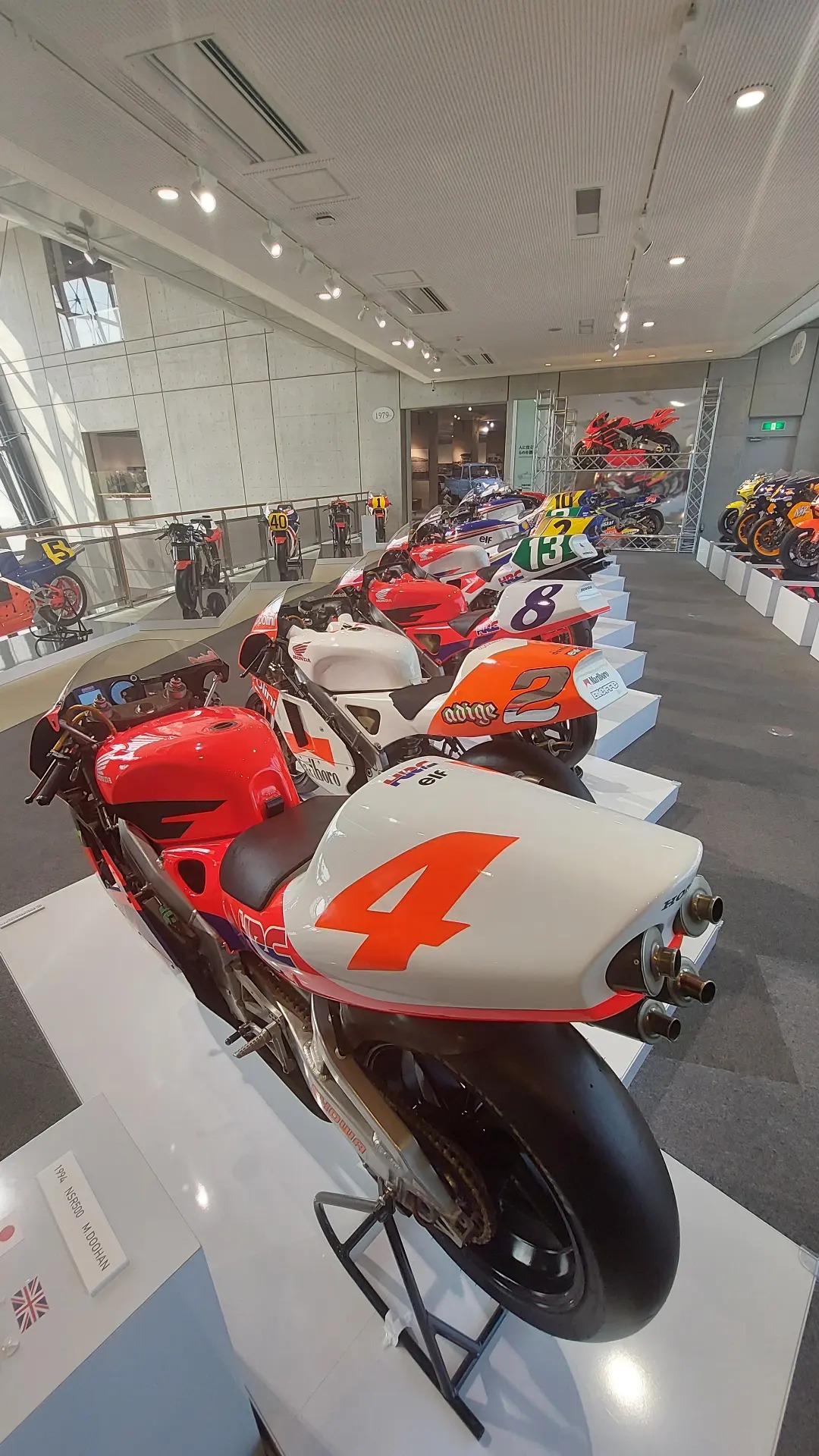 Row of Honda NSR MotoGP racing motorcycles in Repsol and factory liveries