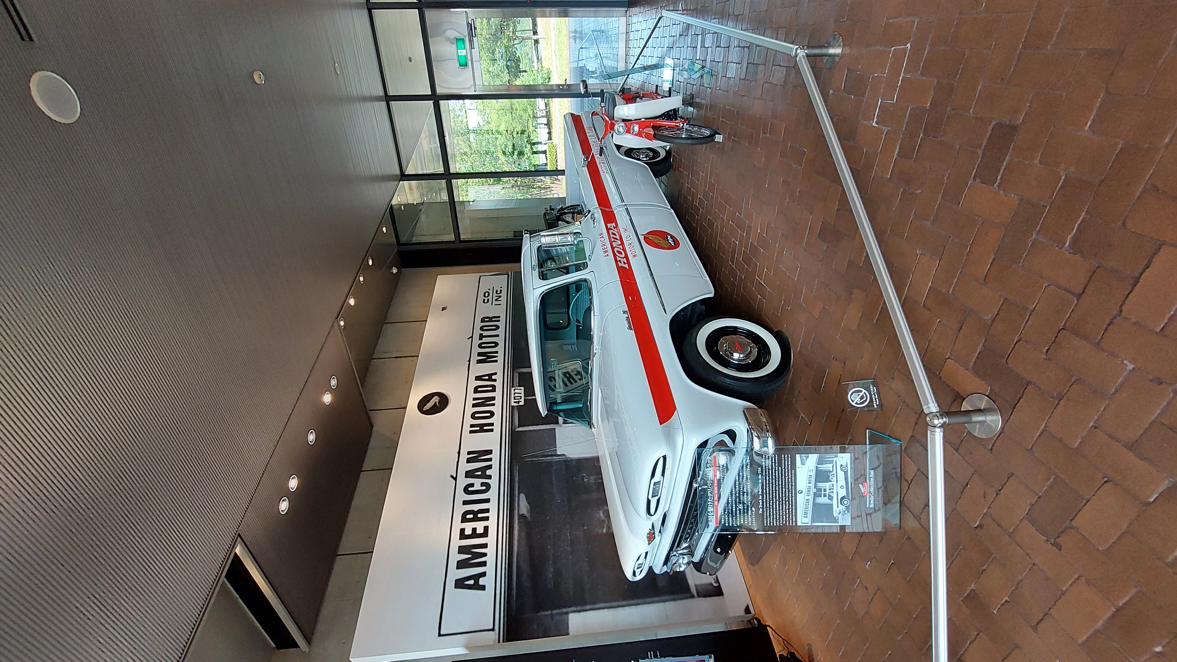 American Honda Motor pickup truck in the atrium, white with red stripe, the vehicle that brought Honda to America