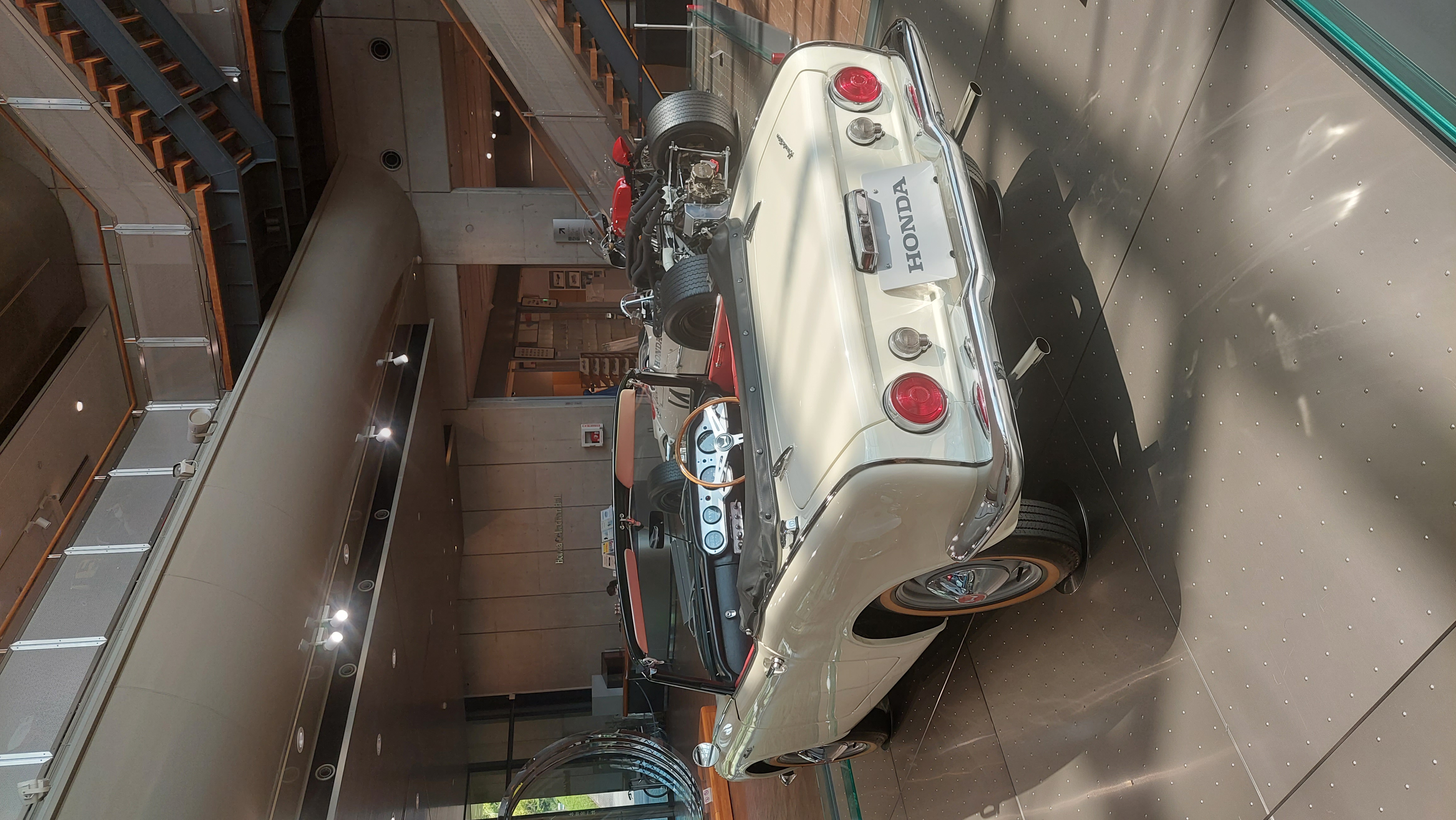 Honda S600 rear view in the entrance atrium, cream white with chrome bumper