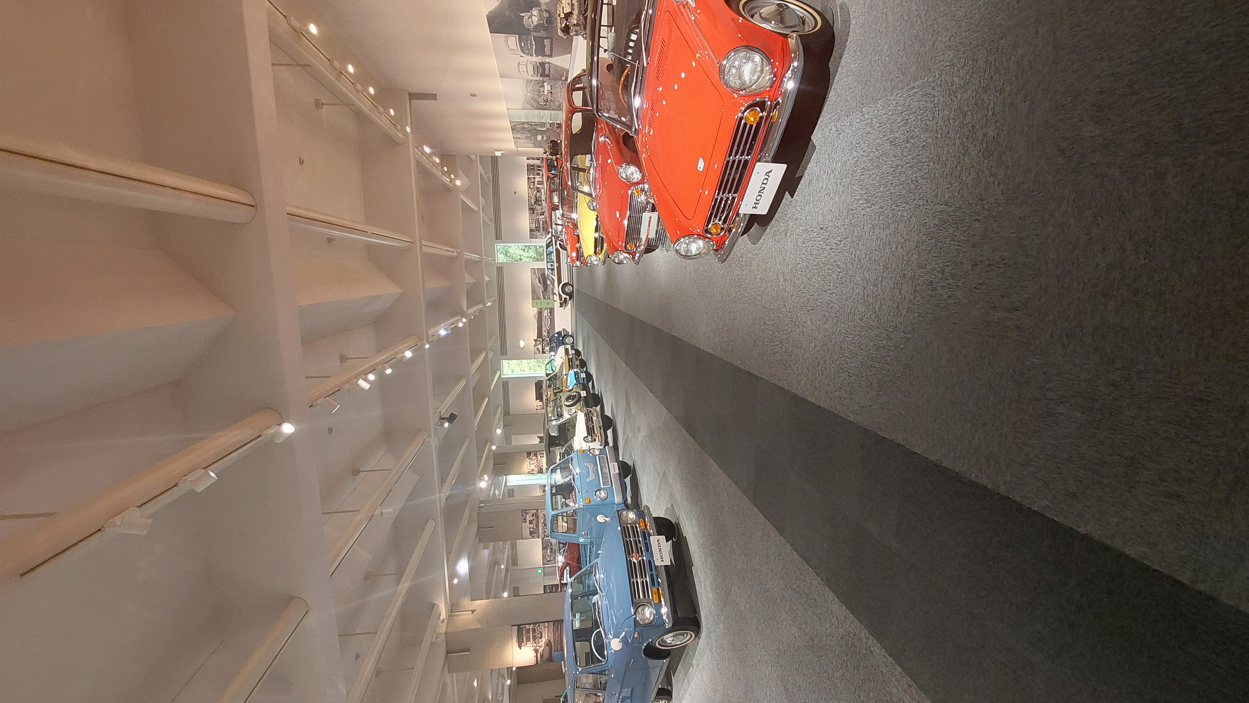 Long row of classic Hondas stretching into the distance, red S800 in the foreground
