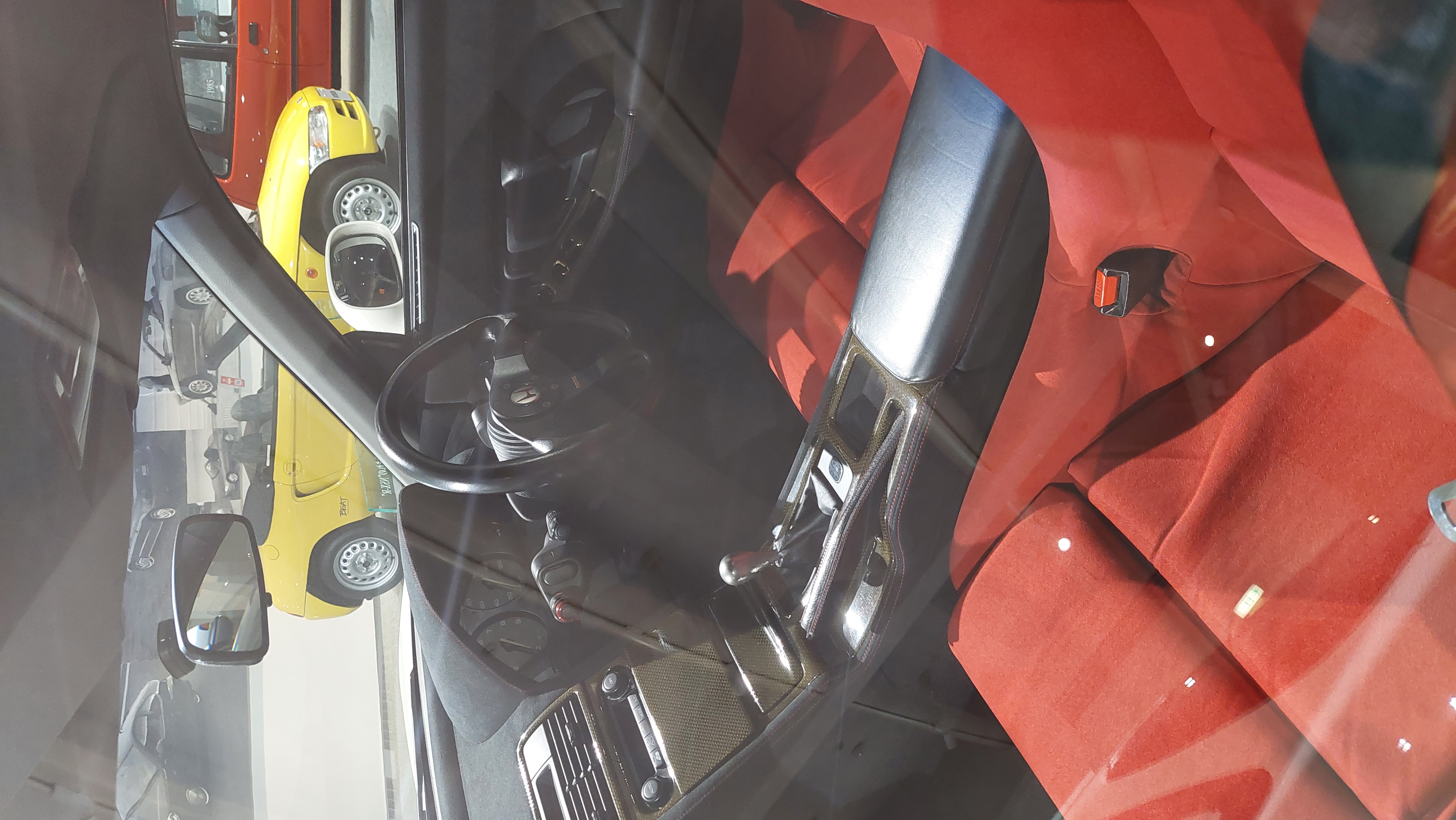 Integra Type R red Recaro interior through the window, Momo steering wheel and short-throw shifter visible
