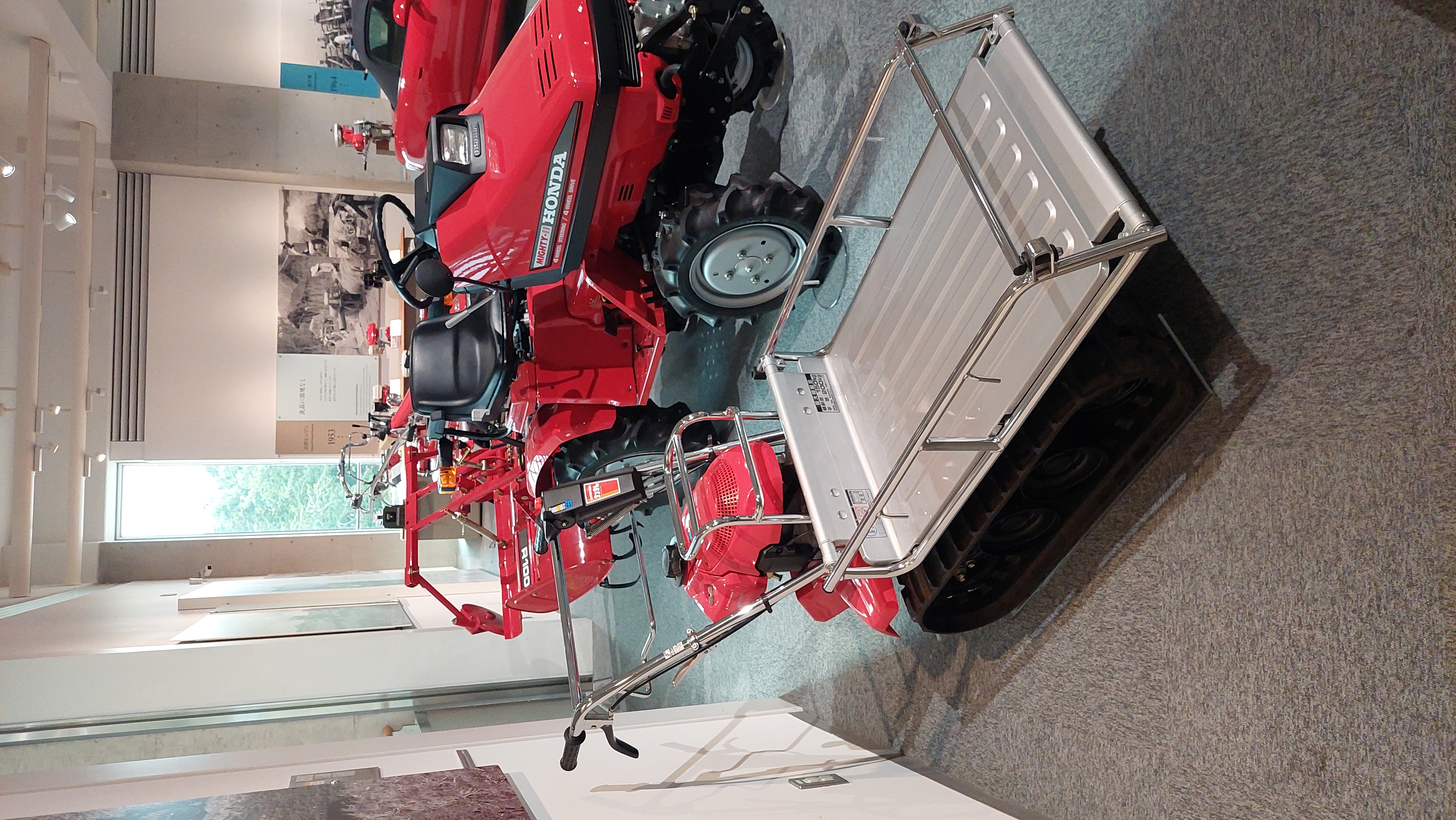 Red Honda power products display including tractor and equipment, showing Honda's reach beyond cars