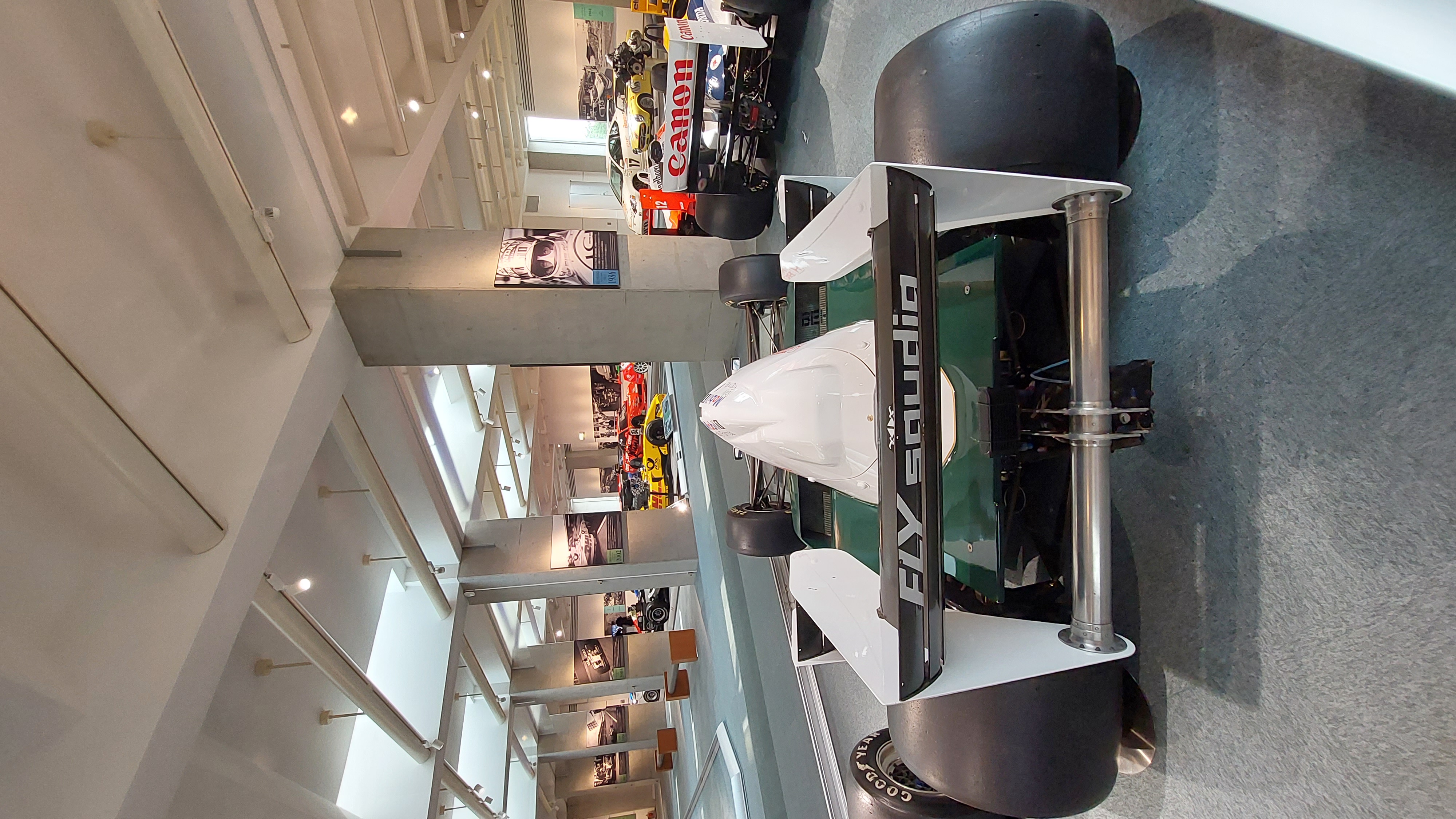 Honda F1 car in green Fly Studio livery with exposed carbon fiber, the elegant brutality of open-wheel racing