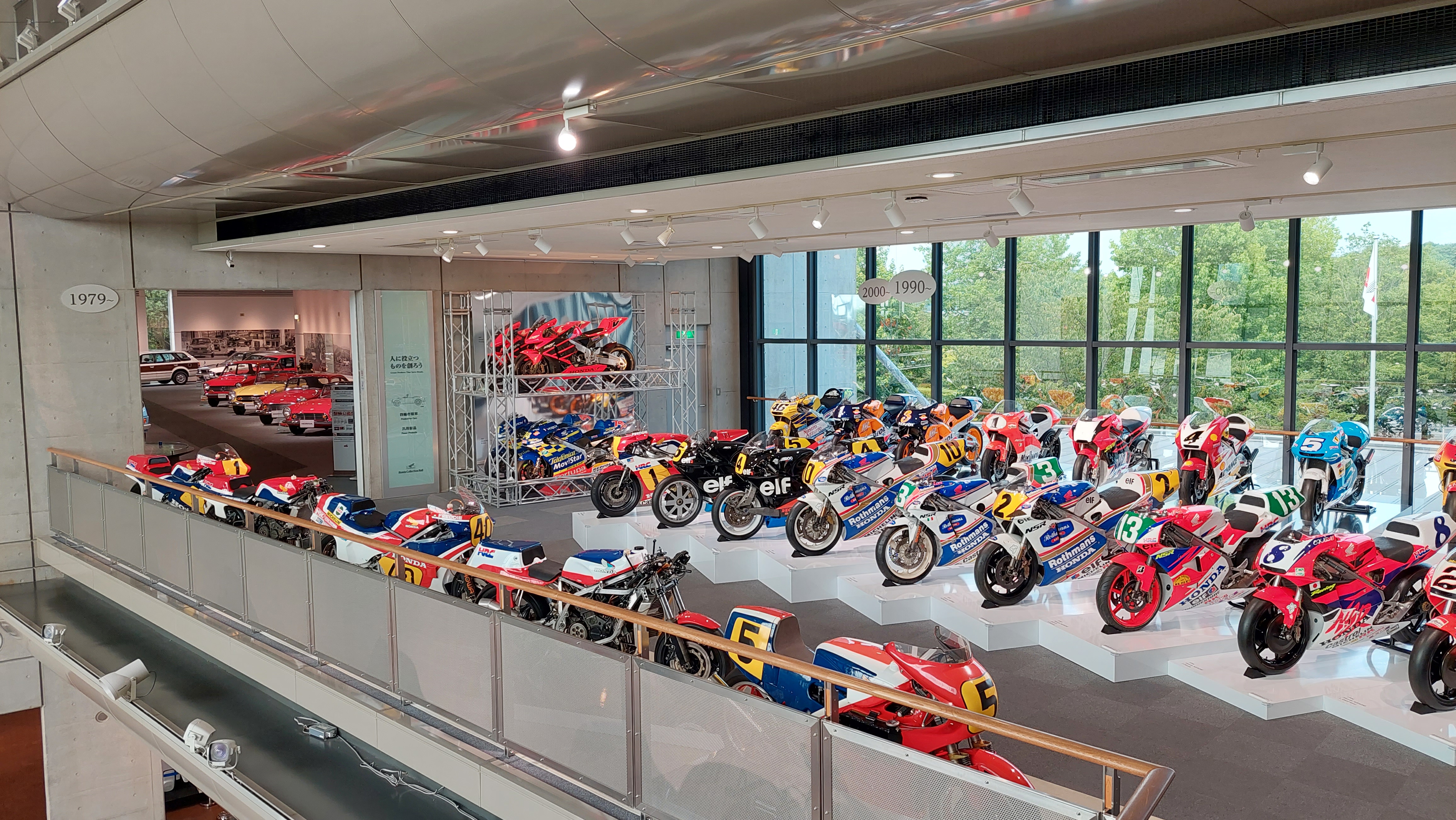 The motorcycle mezzanine from above, rows of MotoGP and grand prix bikes stretching the full length of the building