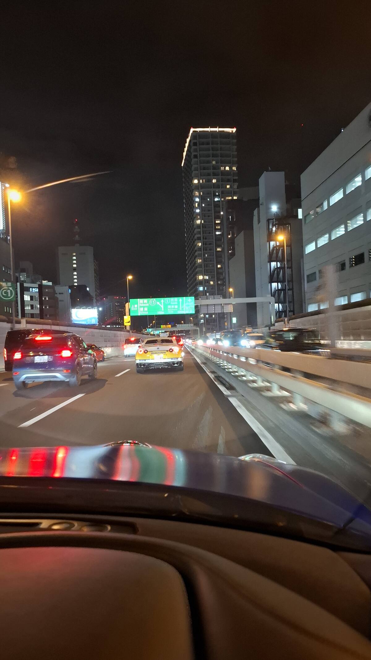 GT-R convoy cruising on the highway with city lights