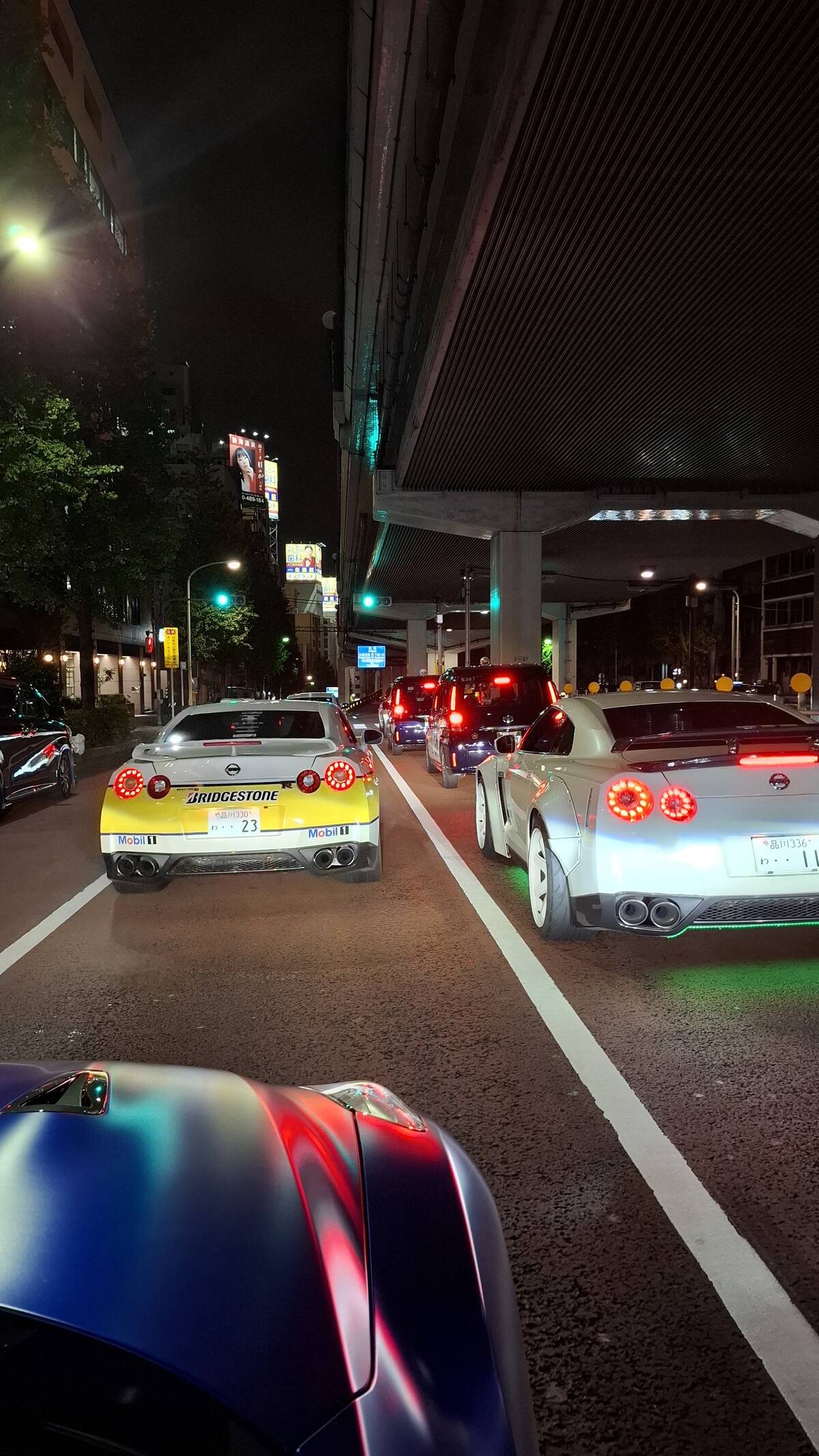 Convoy lined up at a traffic light in downtown Tokyo