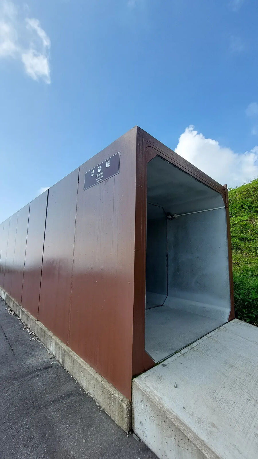 Volcanic emergency shelter at the roadside, brown metal construction designed to protect against eruptions