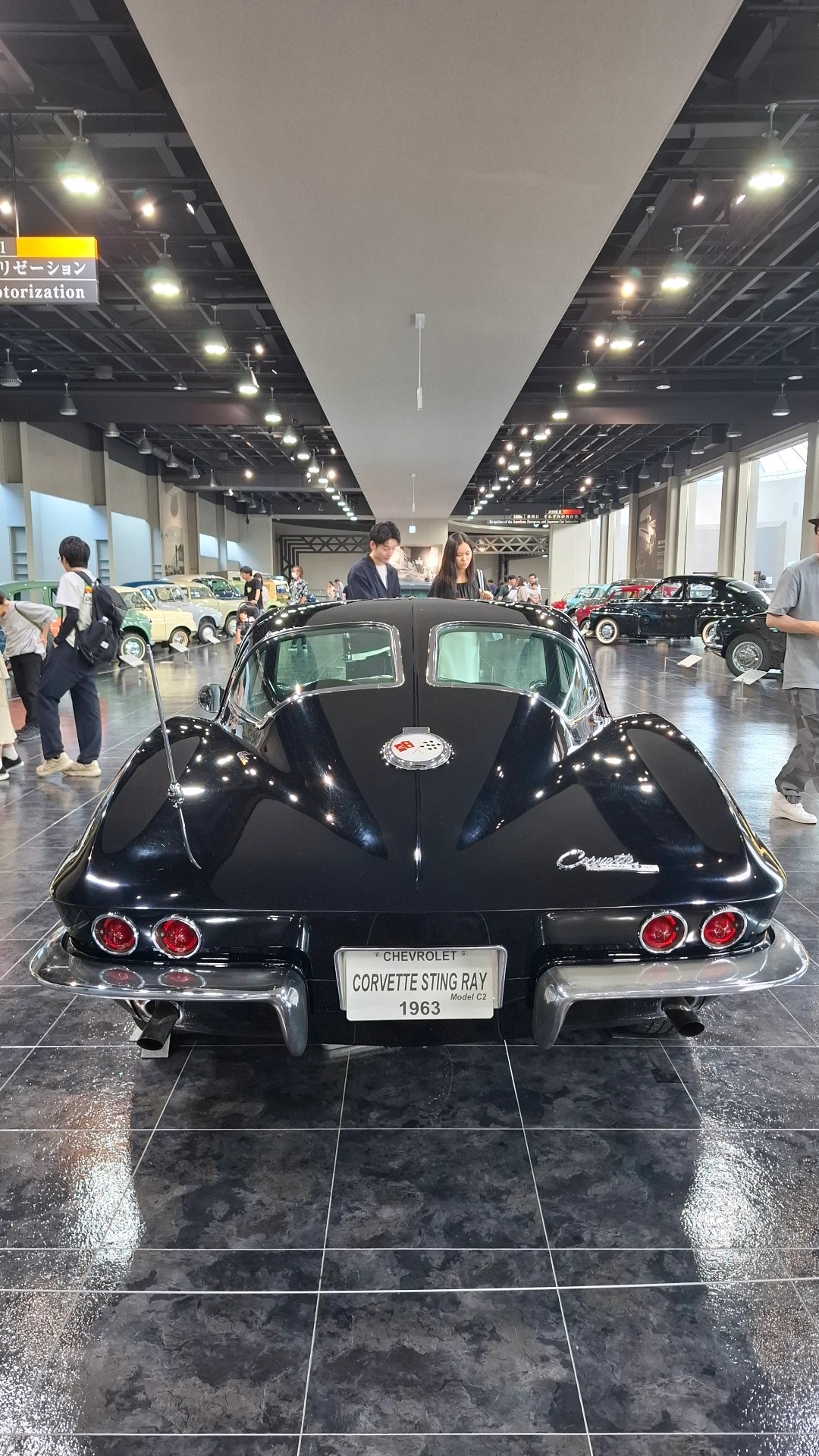 1963 Corvette Sting Ray split-window coupe in black, rear view showing the iconic divided rear window and round taillights