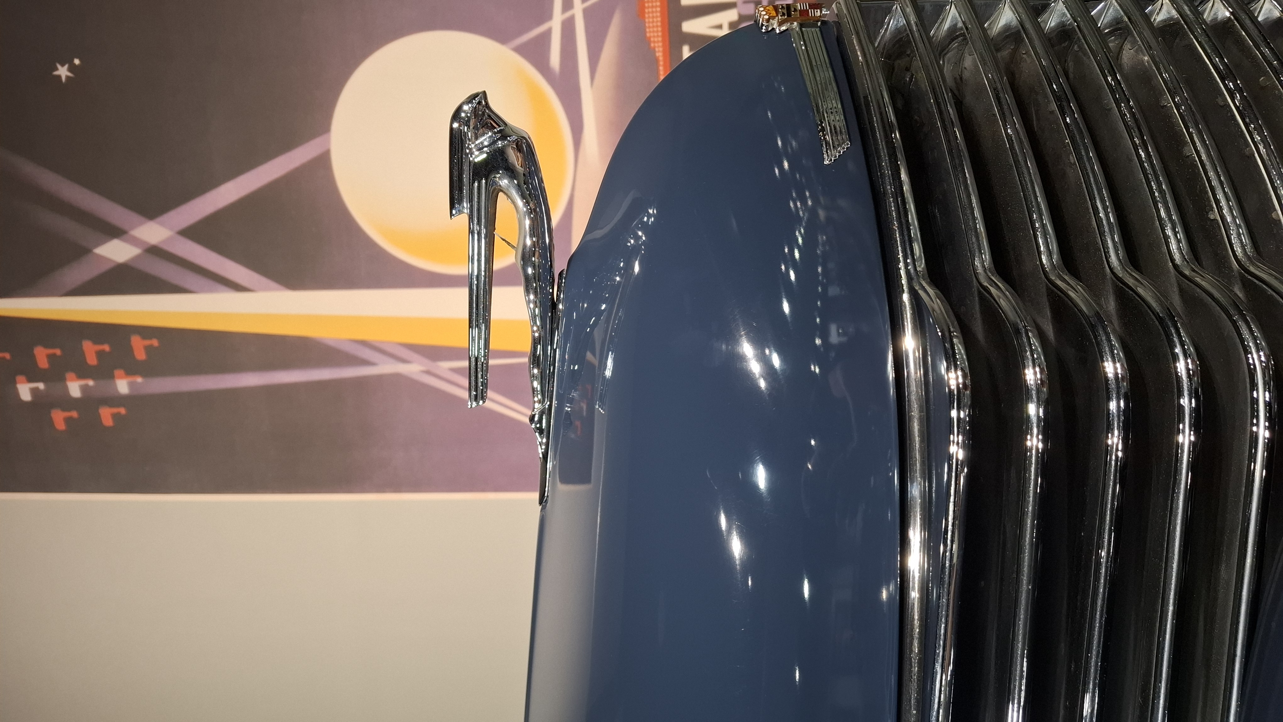 Lincoln greyhound hood ornament against an Art Deco moonlit backdrop painting