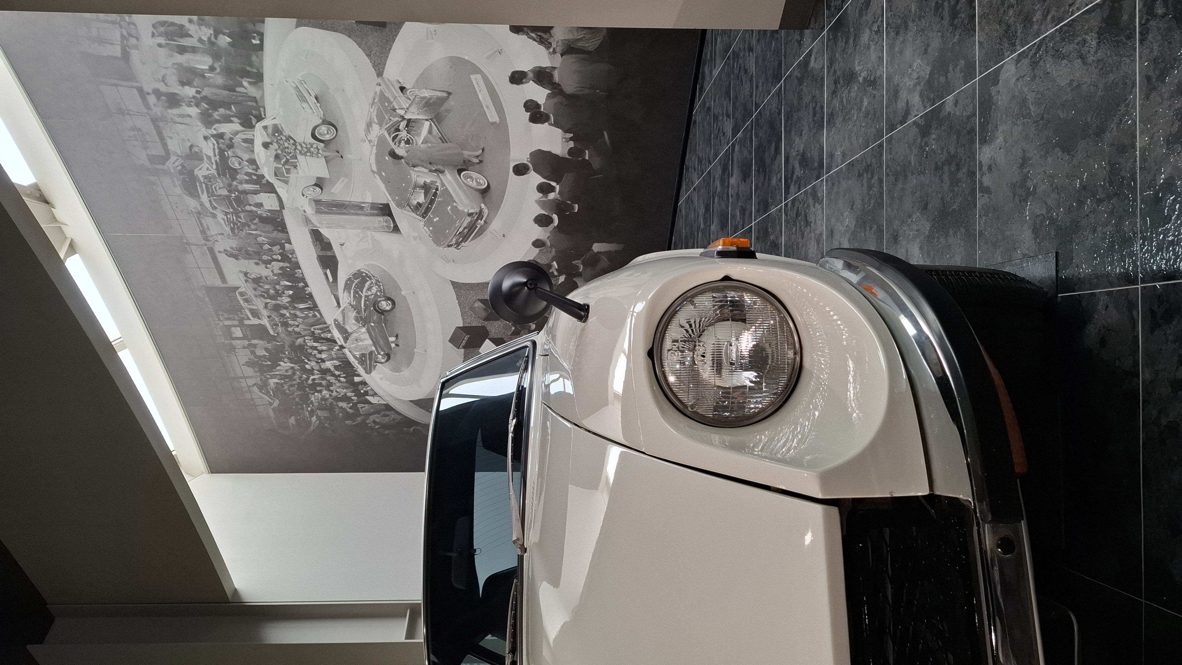 Fairlady Z front view with motor show display photograph behind it