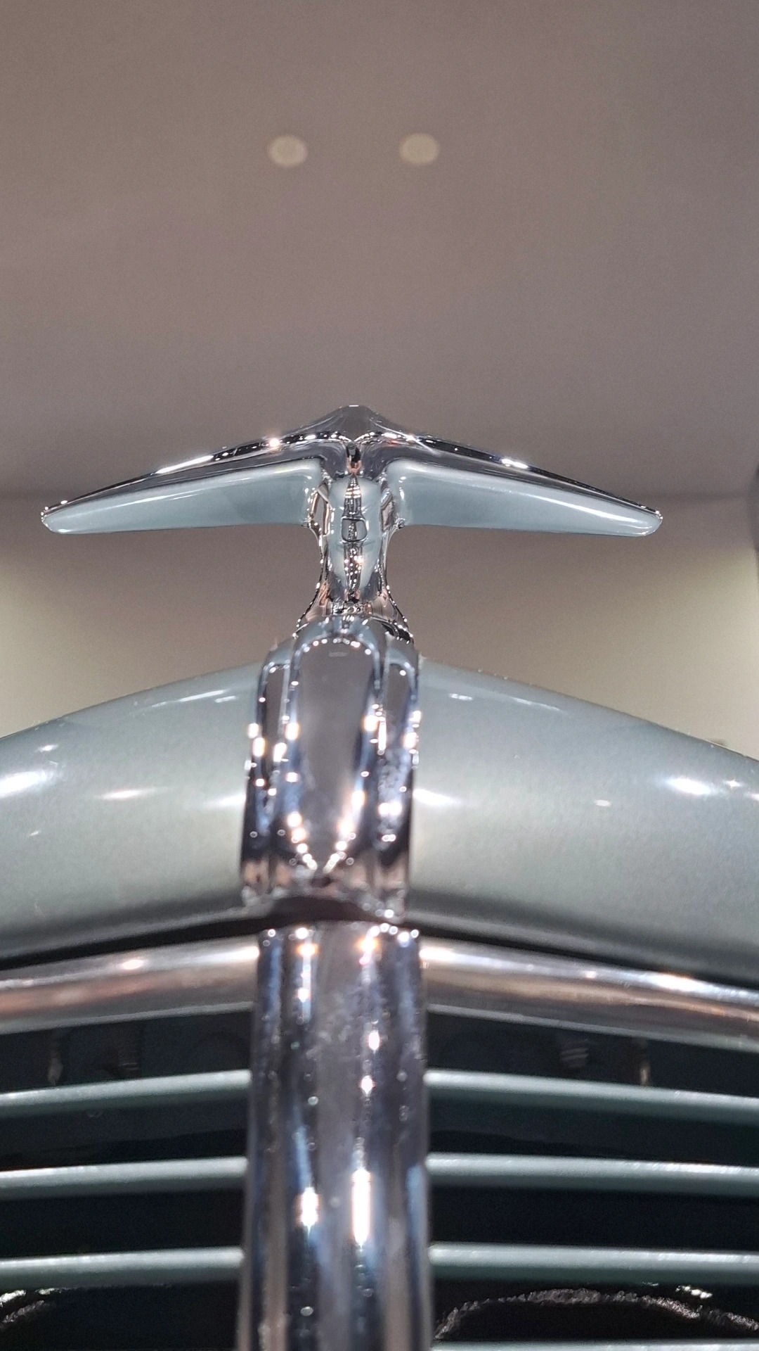 Packard hood ornament: chrome figure leaning into the wind on a classic American luxury car