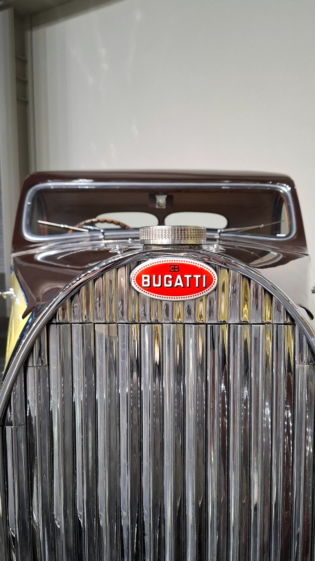 Bugatti red oval badge on the horseshoe grille, vertical chrome slats, the most recognizable face in automotive history
