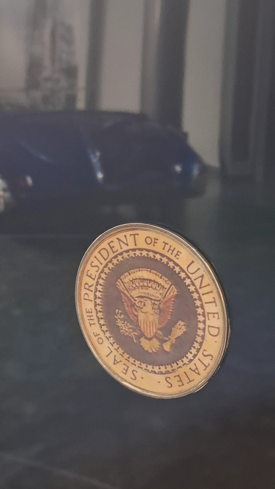 Seal of the President of the United States on the door panel, another car's silhouette reflected in the dark blue paint